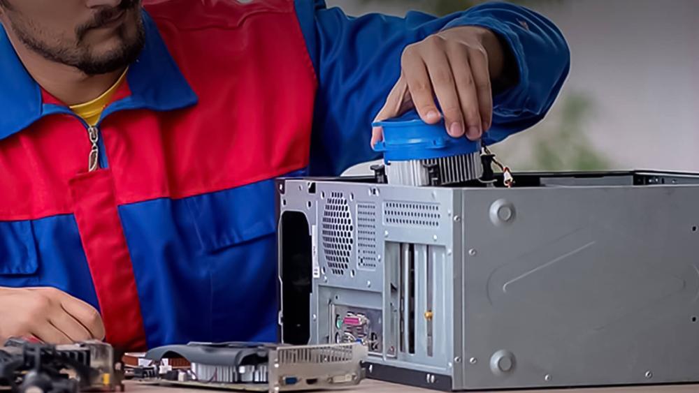 PC technician fixing loud fan issues in a desktop