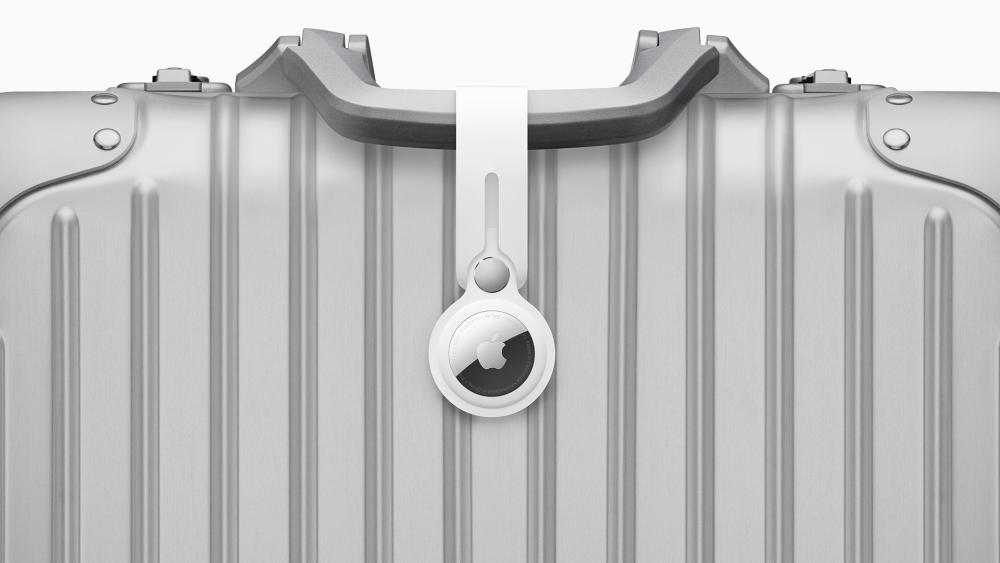 Apple AirTag attached to suitcase for luggage tracking