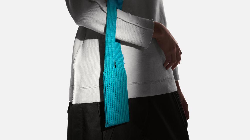 Model wearing the Apple iPhone Pocket in teal blue