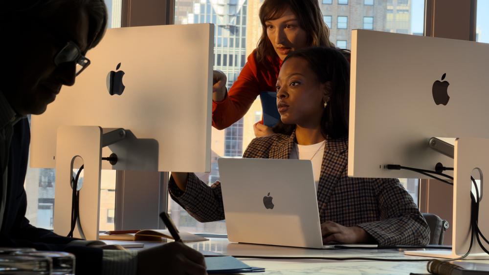 Team working with Apple Studio Display and MacBook