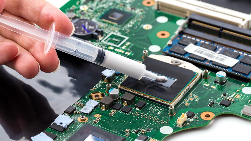 Thermal paste being applied to a laptop CPU during repair