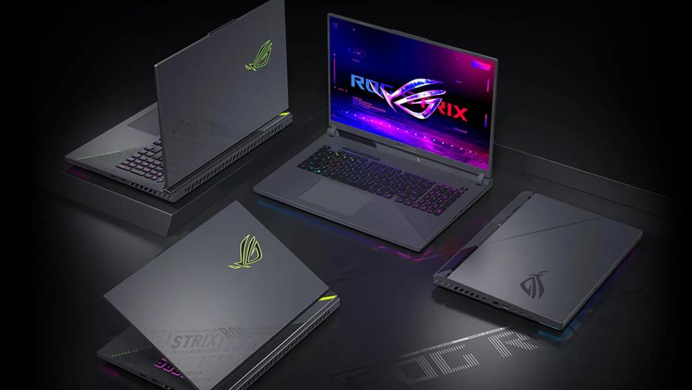 Multiple ASUS ROG Strix gaming laptops shown from different angles with RGB keyboards and illuminated ROG logos.