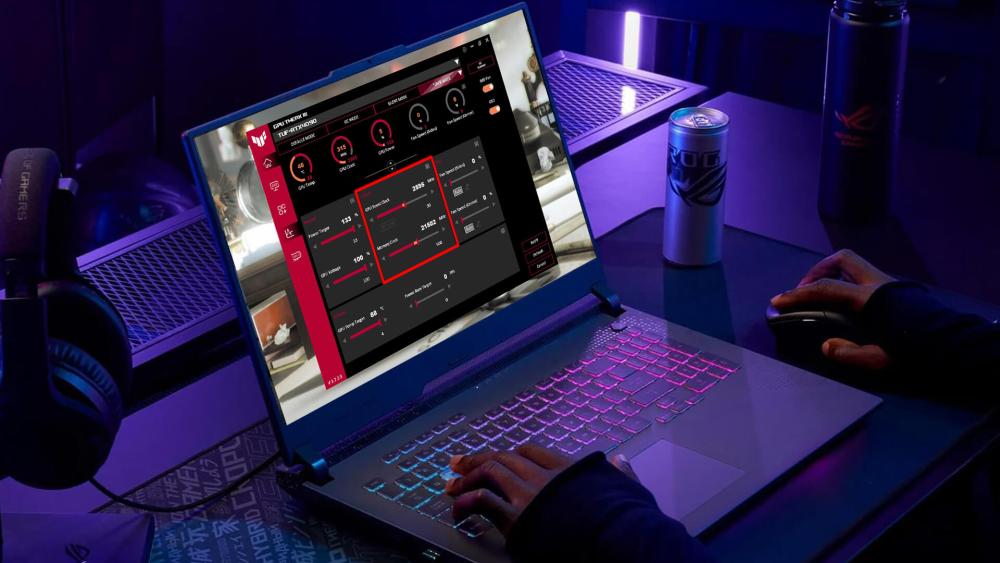 ASUS ROG Strix gaming laptop displaying GPU overclocking controls in Armoury Crate software with RGB keyboard lighting and gaming desk setup.