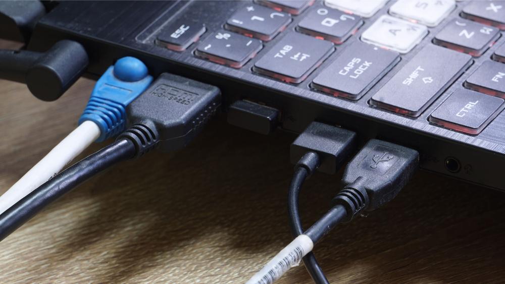 Laptop ports including USB HDMI and Ethernet connections for business use