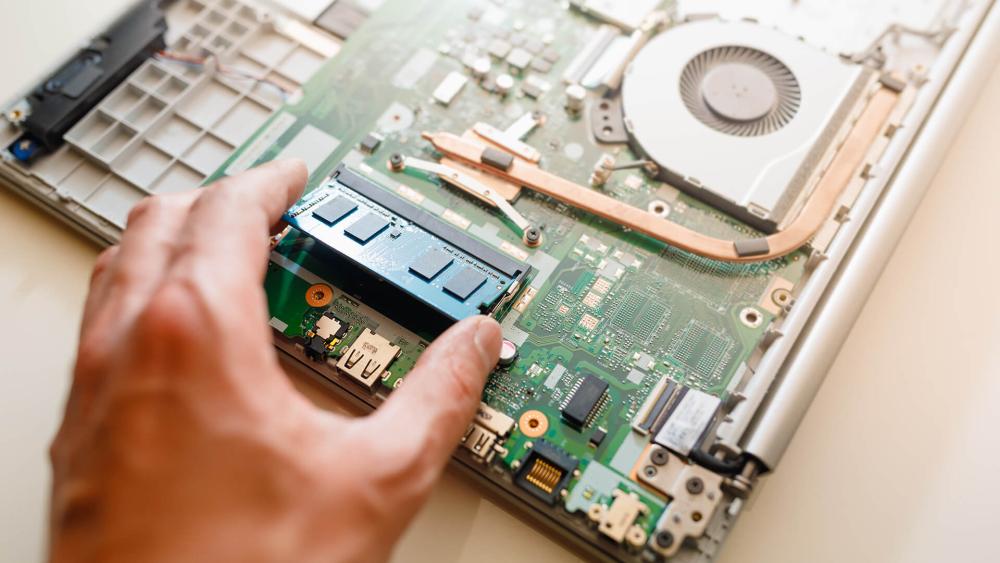 Installing RAM module into laptop motherboard for performance upgrade