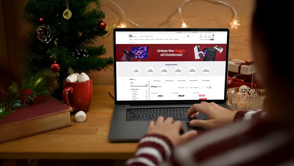 Person browsing Box.co.uk Christmas tech gift deals on laptop