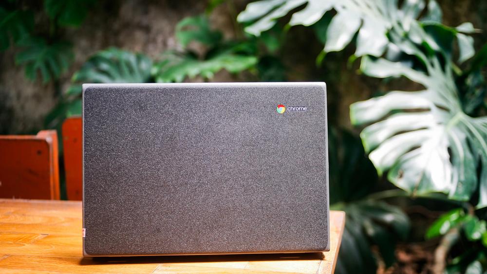 Chromebook laptop placed outdoors on a wooden table highlighting portable design and everyday usability