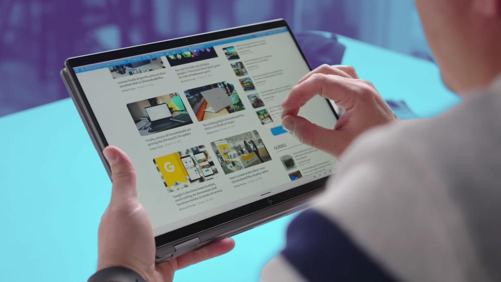 Person using a Chromebook tablet with touchscreen to browse web content, guides and articles in a portable lightweight format