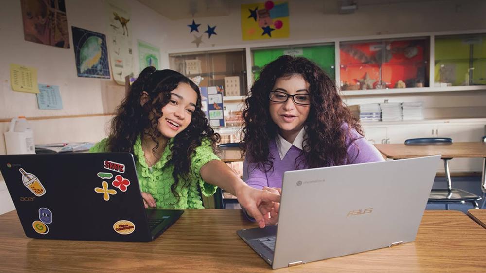 Students using Chromebooks together in a classroom for schoolwork