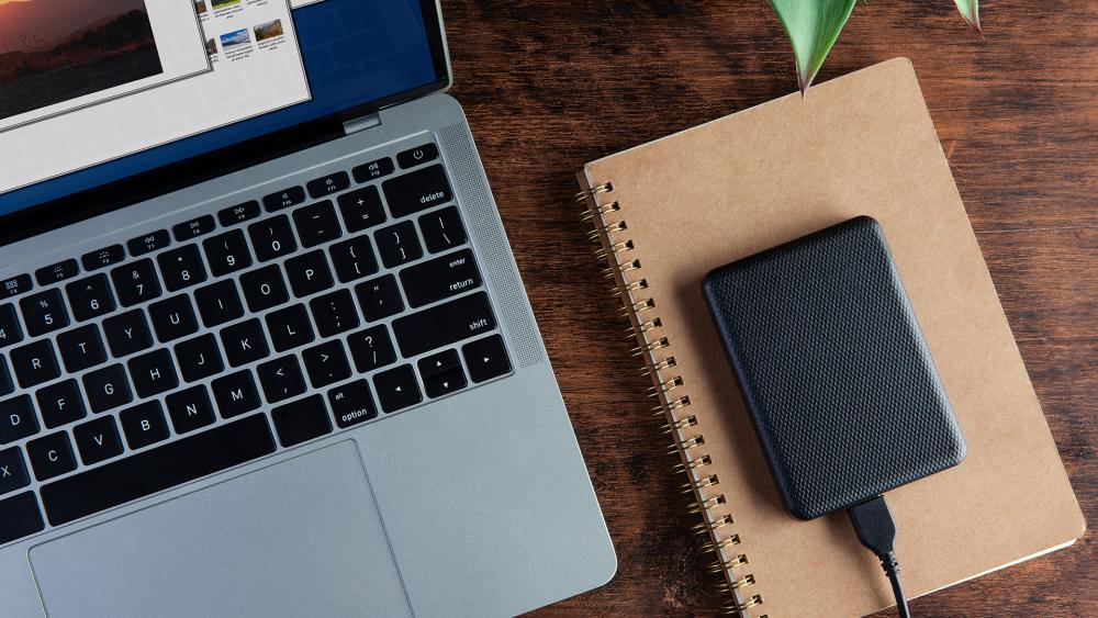 External hard drive connected to laptop during file backup process