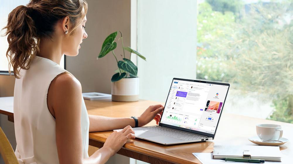 Professional using Copilot Plus business laptop for productivity and office work