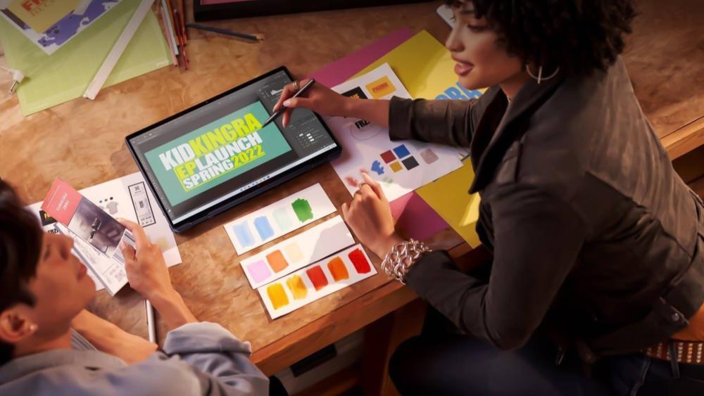 Designer creating branding visuals on a touchscreen laptop