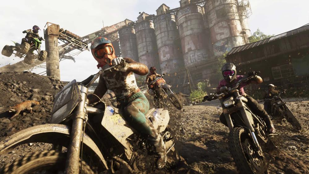 Dirt bike racers speeding through an industrial scrapyard track