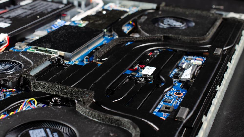 Close-up of dusty laptop fans and cooling system inside ROG Strix