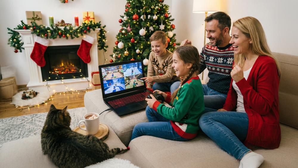 Family playing cozy Christmas video games together in living room