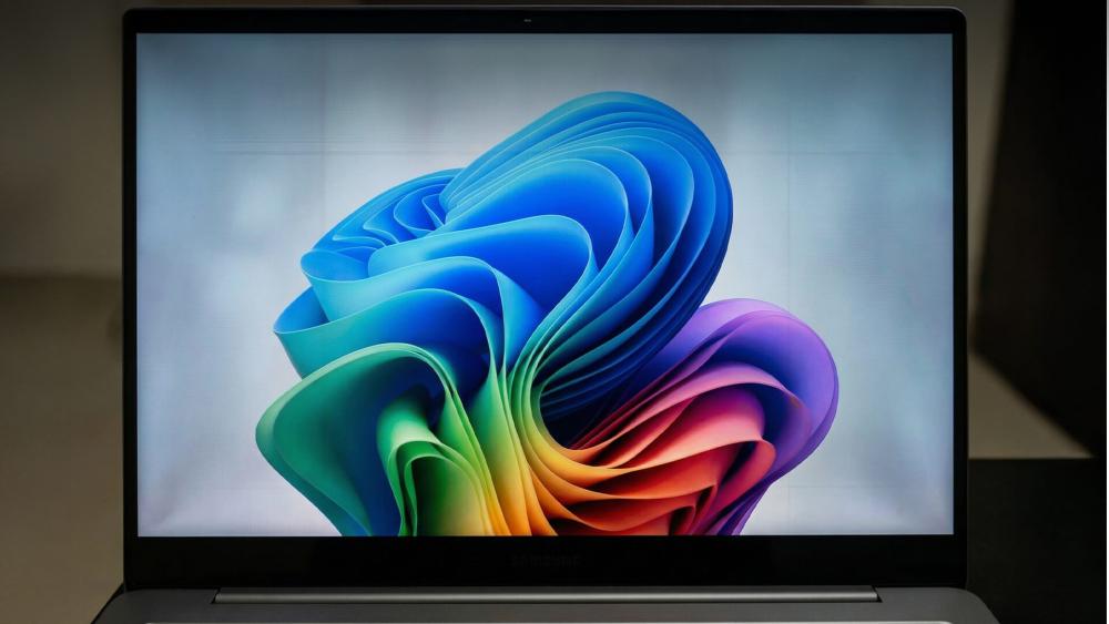 Samsung laptop displaying colourful abstract wallpaper on AMOLED screen