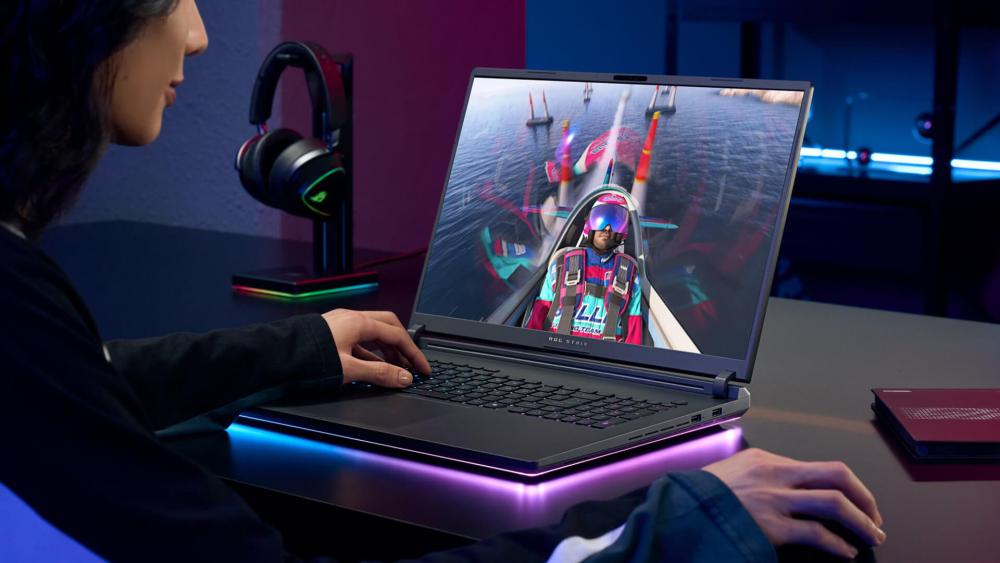 Gamer playing on a high-performance laptop with RGB setup