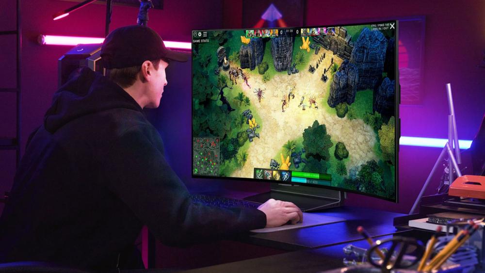 PC gamer playing a top-down strategy game on a 1440p gaming monitor