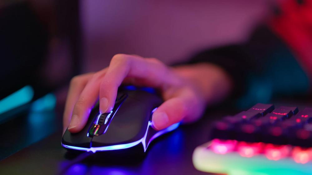 Close-up of hand gripping gaming mouse showing lift-off control