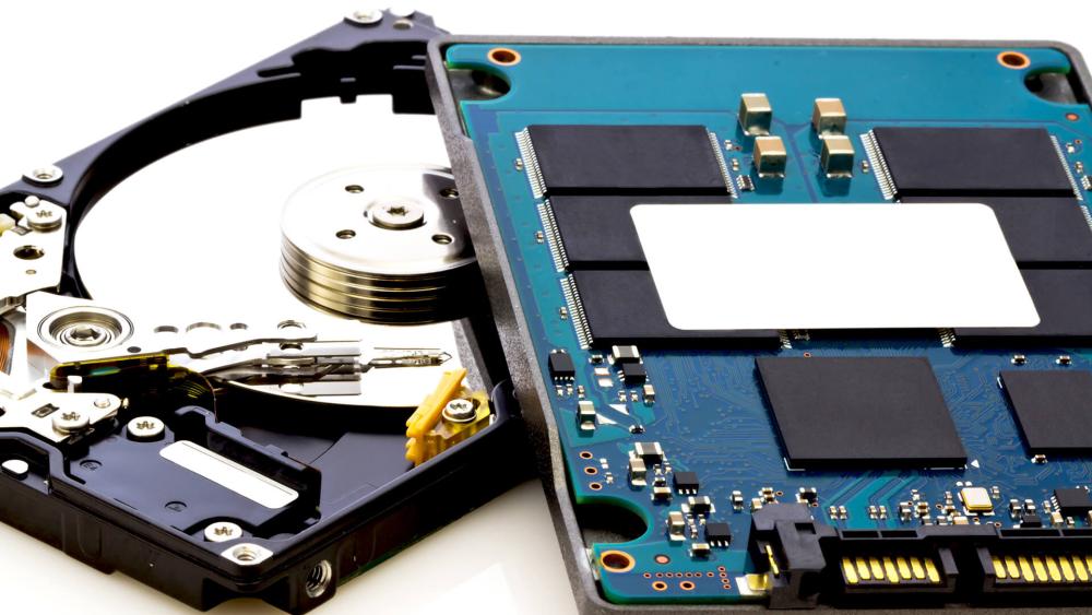Close-up comparison of HDD and SSD internal components showing mechanical disk parts and solid state memory chips