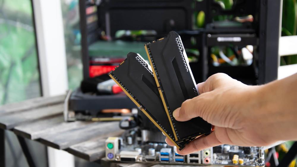 User holding DDR5 RAM modules for PC memory upgrade setup