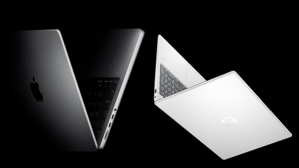 HP vs MacBook comparison showing both laptops open