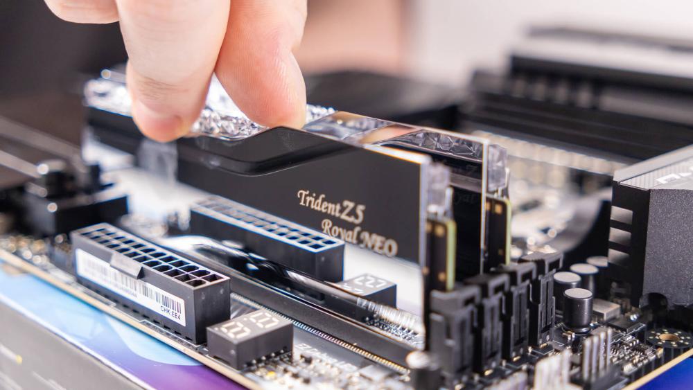 User installing DDR5 RGB RAM into motherboard for system upgrade