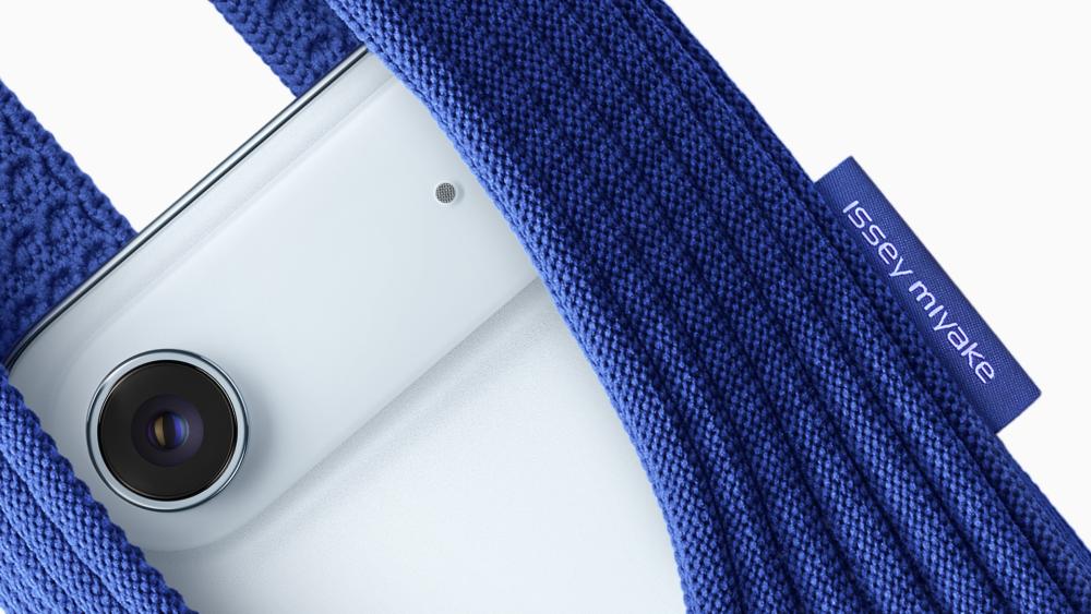 Close-up of iPhone inside blue Apple x Issey Miyake pocket