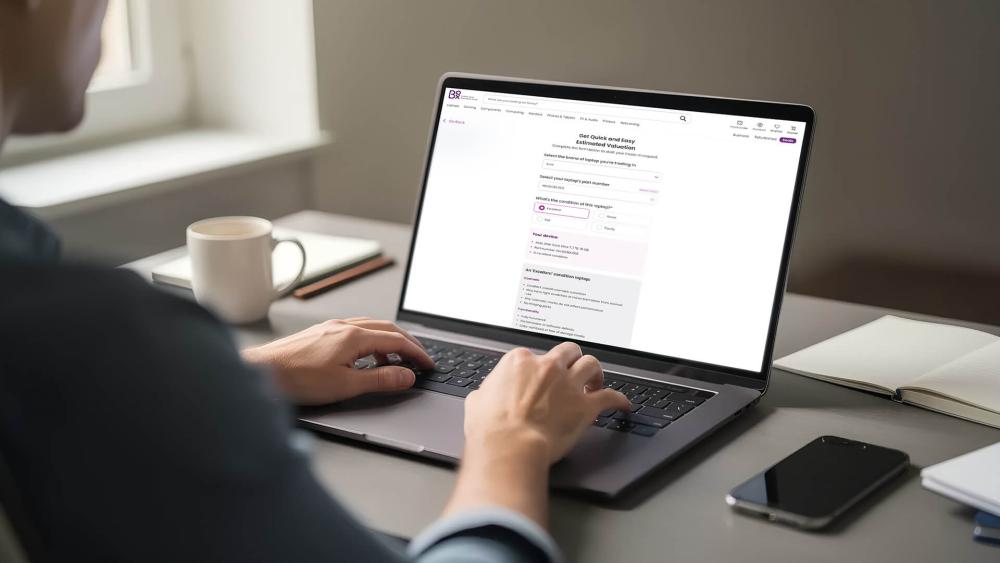 User checking laptop trade-in value online on a modern laptop.