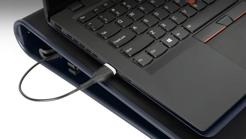 Lenovo laptop placed on a cooling stand for airflow