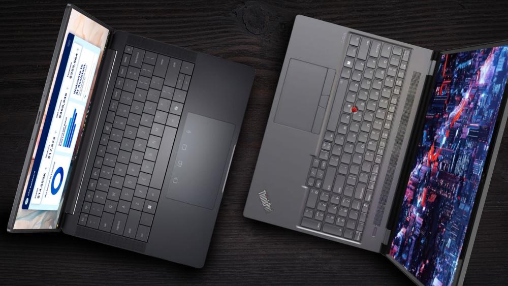 Top view comparison of Lenovo ThinkPad and Dell business laptops showing keyboards and displays on a dark surface
