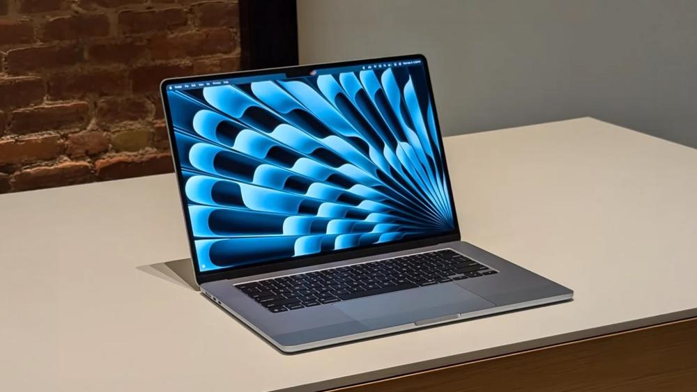 MacBook Air open on desk displaying macOS interface