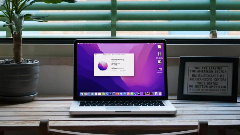 MacBook showing macOS Monterey on a desk setup