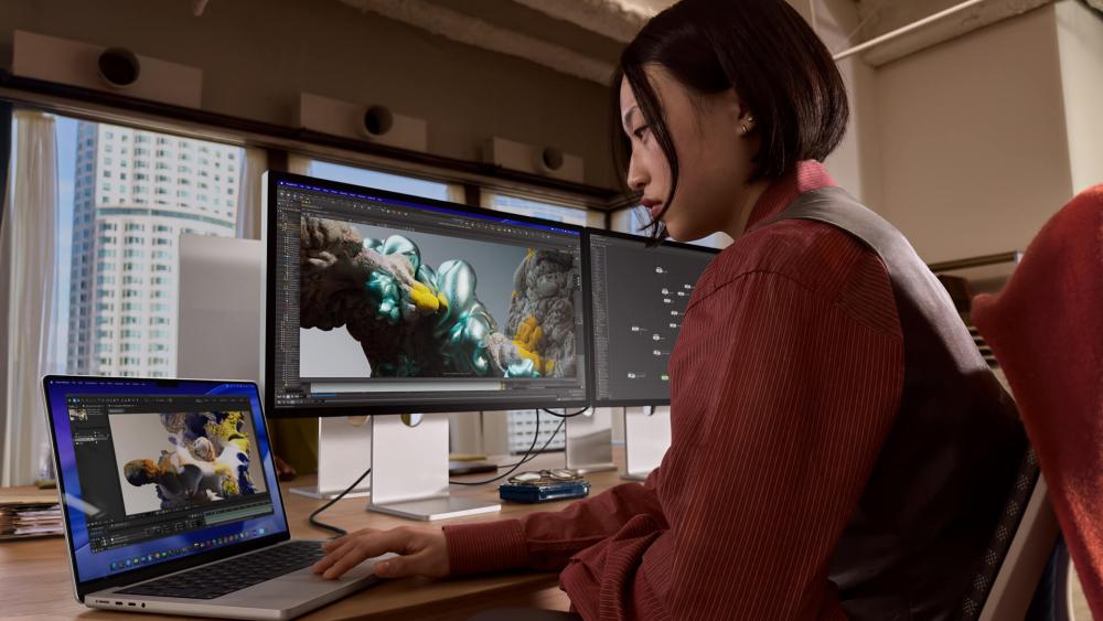 MacBook Pro setup for video editing with dual monitor workflow
