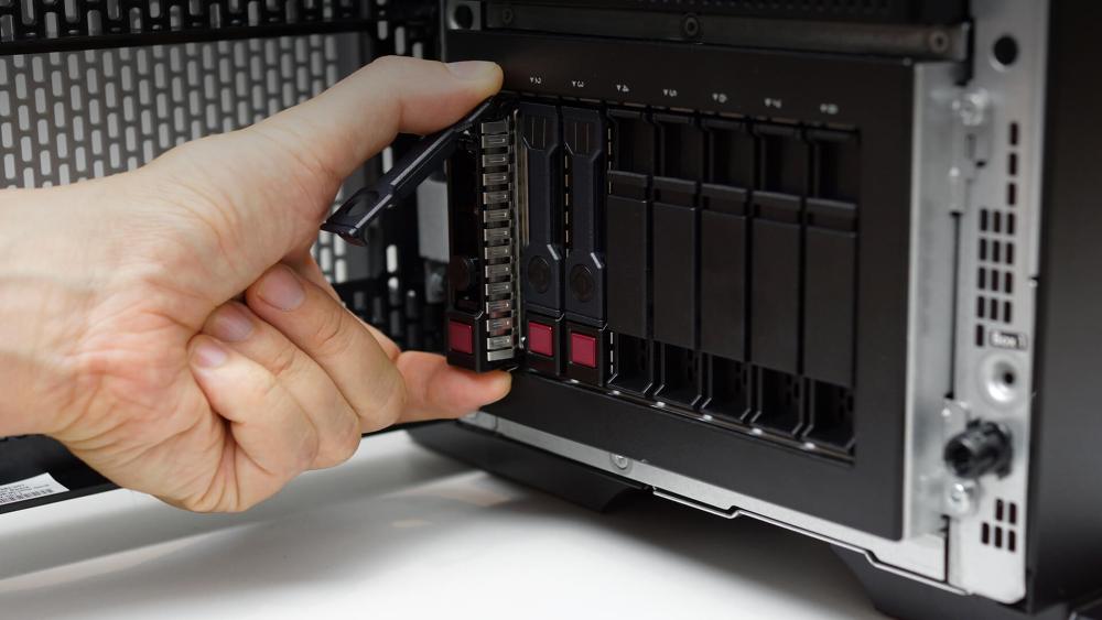 Person installing hot-swappable drive in NAS enclosure