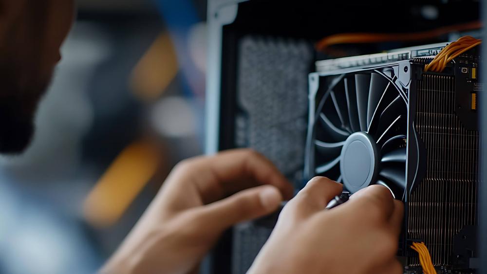 Person installing a cooling fan inside a computer case