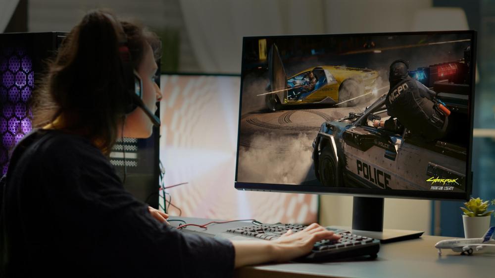 PC gamer playing Cyberpunk 2077 on a desktop monitor