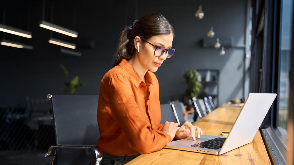 Professional working on a business laptop in a modern office environment
