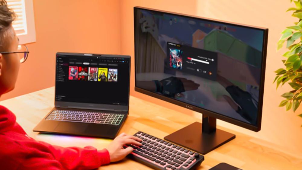 User gaming on external monitor using a laptop and desktop setup