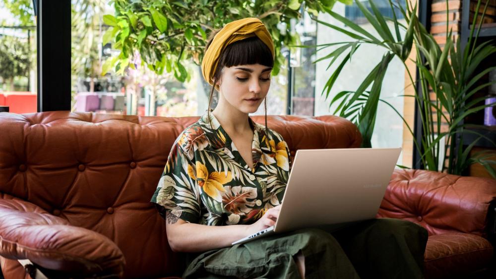 A user working on a sleek laptop, implying fast performance and productivity