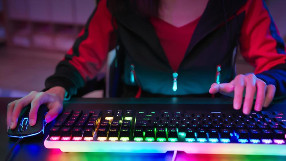 Gamer using an RGB mechanical keyboard