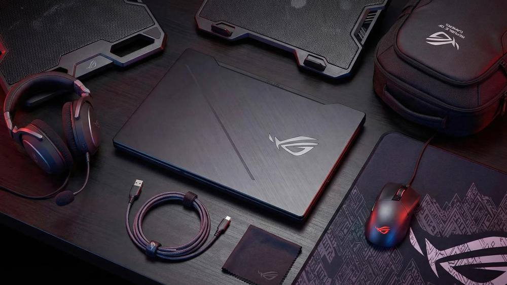 ROG gaming laptop with mouse headset and cooling pad