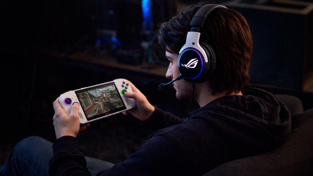 Gamer playing ASUS ROG Xbox Ally with headset