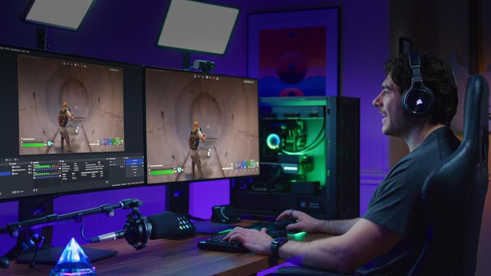 Streamer gaming on dual monitors with RGB-lit PC and OBS software open