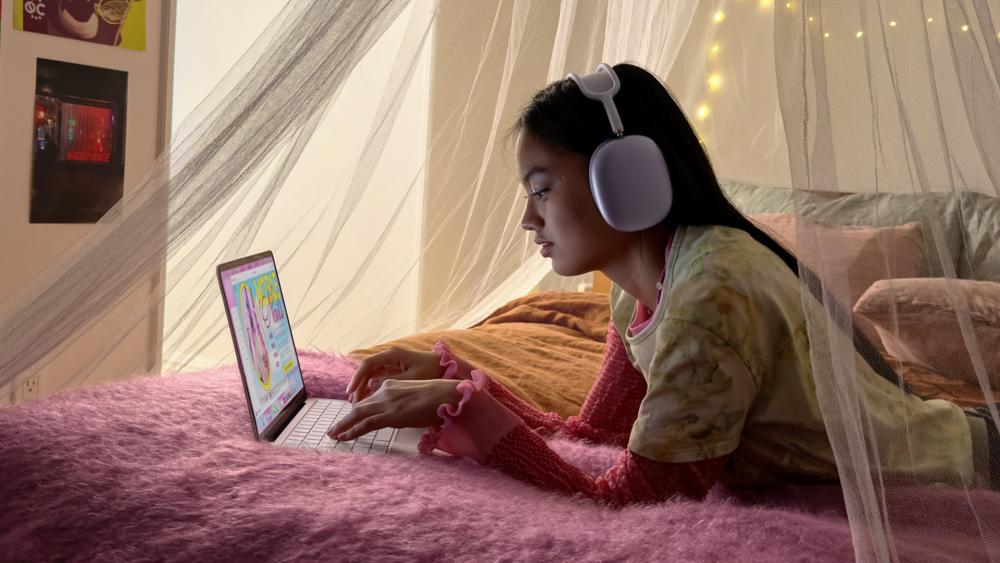 Student studying on MacBook laptop at home