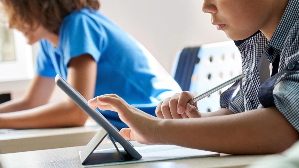 Student using a tablet with a stylus for classroom work