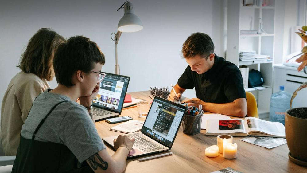 Students comparing laptops for study and group work
