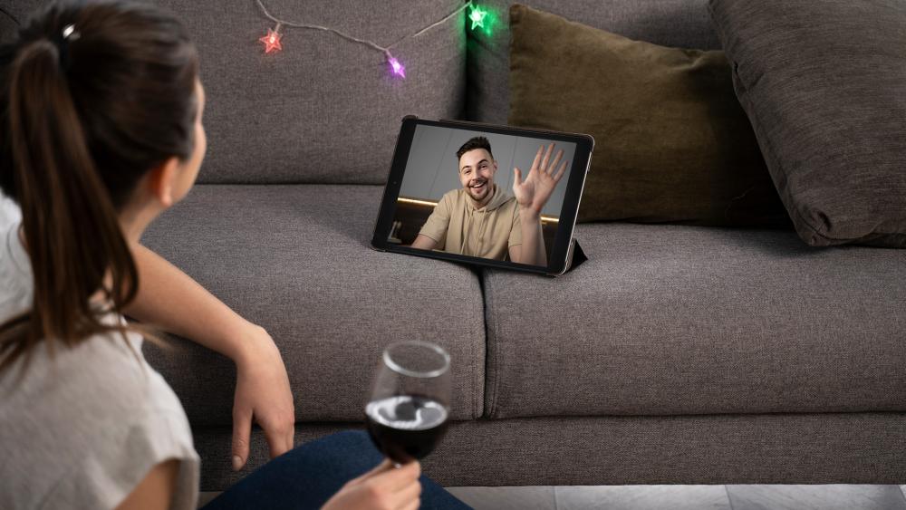 Person watching a video on a tablet while relaxing on the sofa at home