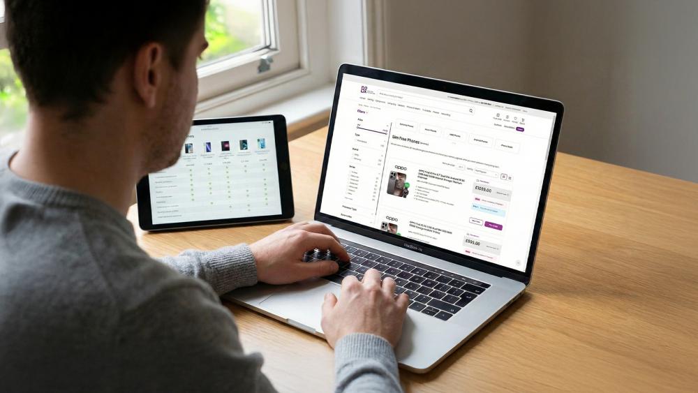 UK customer browsing SIM-free smartphone deals online on a laptop