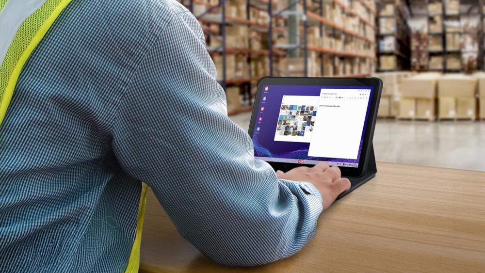 Warehouse worker using a rugged tablet for inventory tasks